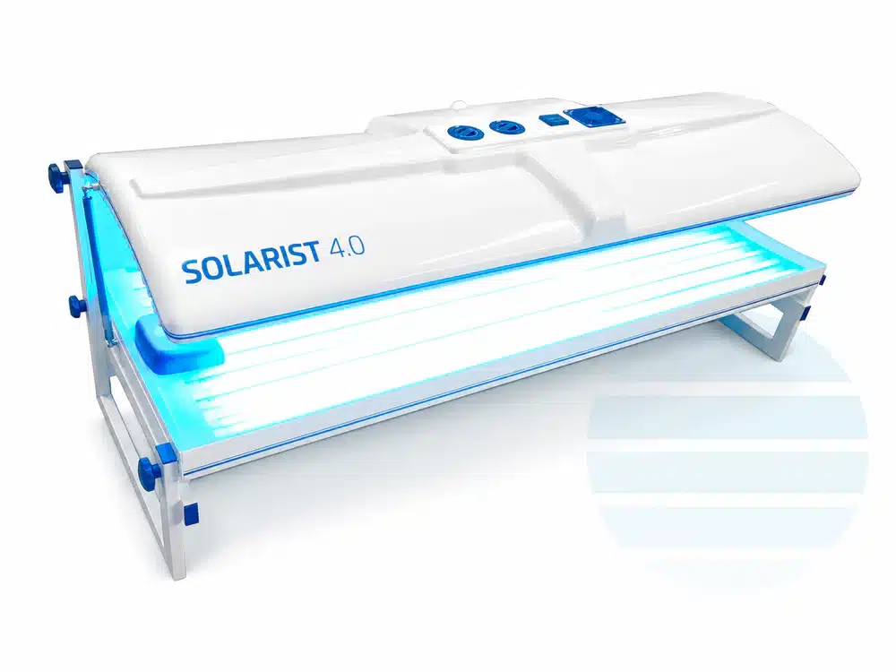 Best Home Tanning Beds For Indoor Use 18 A white and blue sunbed labelled "SOLARIST 4.0" with glowing UV lights inside and a minimalist striped logo on the ground nearby.