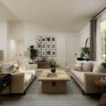 A modern living room with two beige sofas, a wooden coffee table, wall art, indoor plants, and large windows with curtains letting in natural light.
